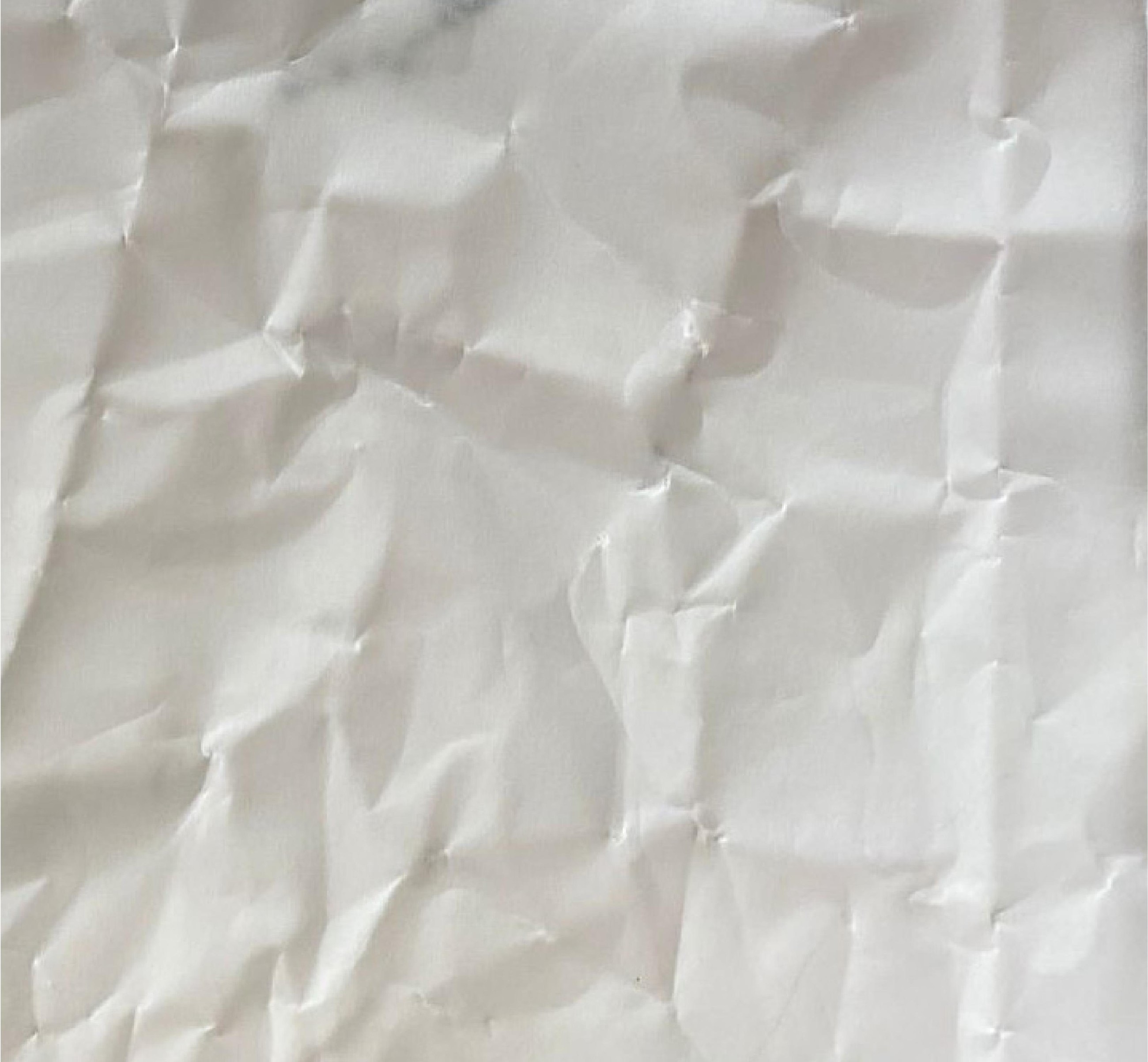 Crumpled butter paper, creased and unfolded, filling the field